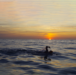 Swimmer and sunrise