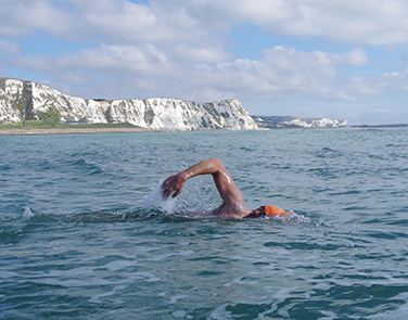 Swimmer with the White Cliffs in background